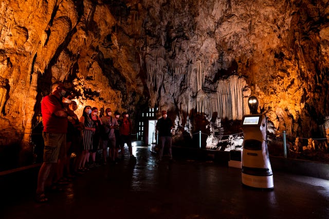 2-61804413 Persephone guides visitors inside Alistrati cave, north-east of Thessaloniki, Greece