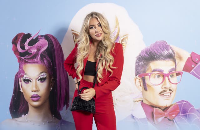 2-68688351 Woman stood in red suit with crop top
