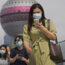 People wearing face masks using their smartphones as they walk on a bridge in Shanghai in China