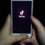 A girl uses the TikTok app on a smartphone