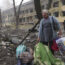 A woman walks outside a maternity hospital that was damaged by shelling in Mariupol, Ukraine