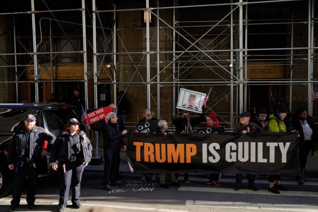 29526044c7be4ebcb786859d03a3abe5 People protest in front of the District Attorney office ahead of former President Donald Trump’s anticipated indictment on Tuesday