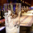 An empty pint glass on a bar