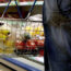 A person holding a shopping basket in a supermarket