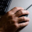 Someone holding a computer mouse (Adam Peck/PA)