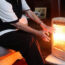 A woman warming herself with an electric fire