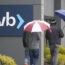 People walk past a Silicon Valley Bank sign at the company's headquarters in California