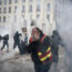 Protesters run amid the tear gas during a demonstration in Lyon
