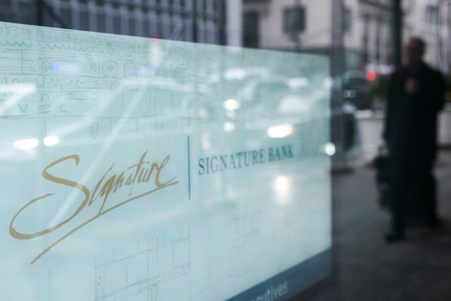 84098f56294b44489ce75cdd14db4c78 A sign is displayed at a branch of Signature Bank in New York