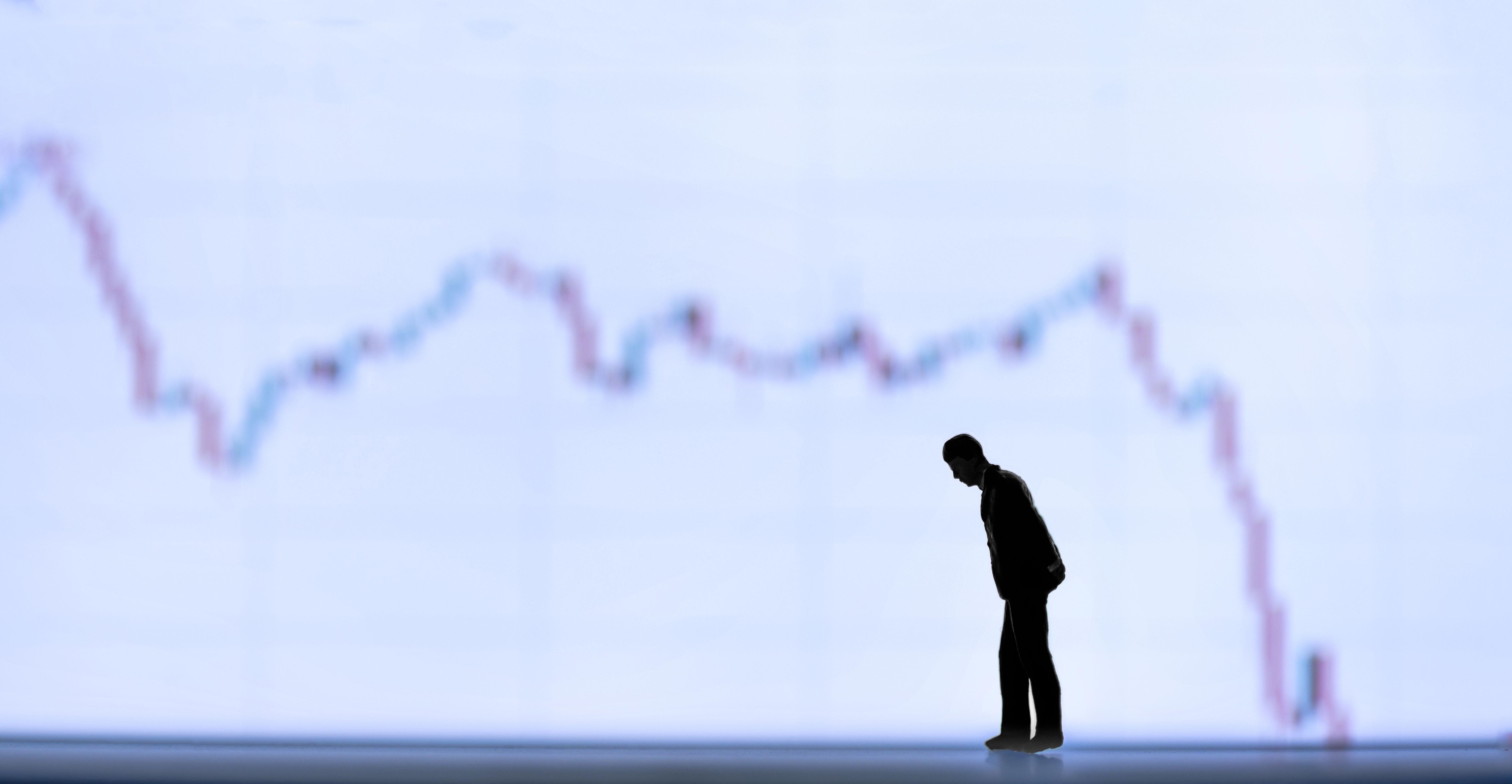 b1b4af9d-281c-4d29-bbe0-8188c73e03dd A mini figure in front of a financial chart