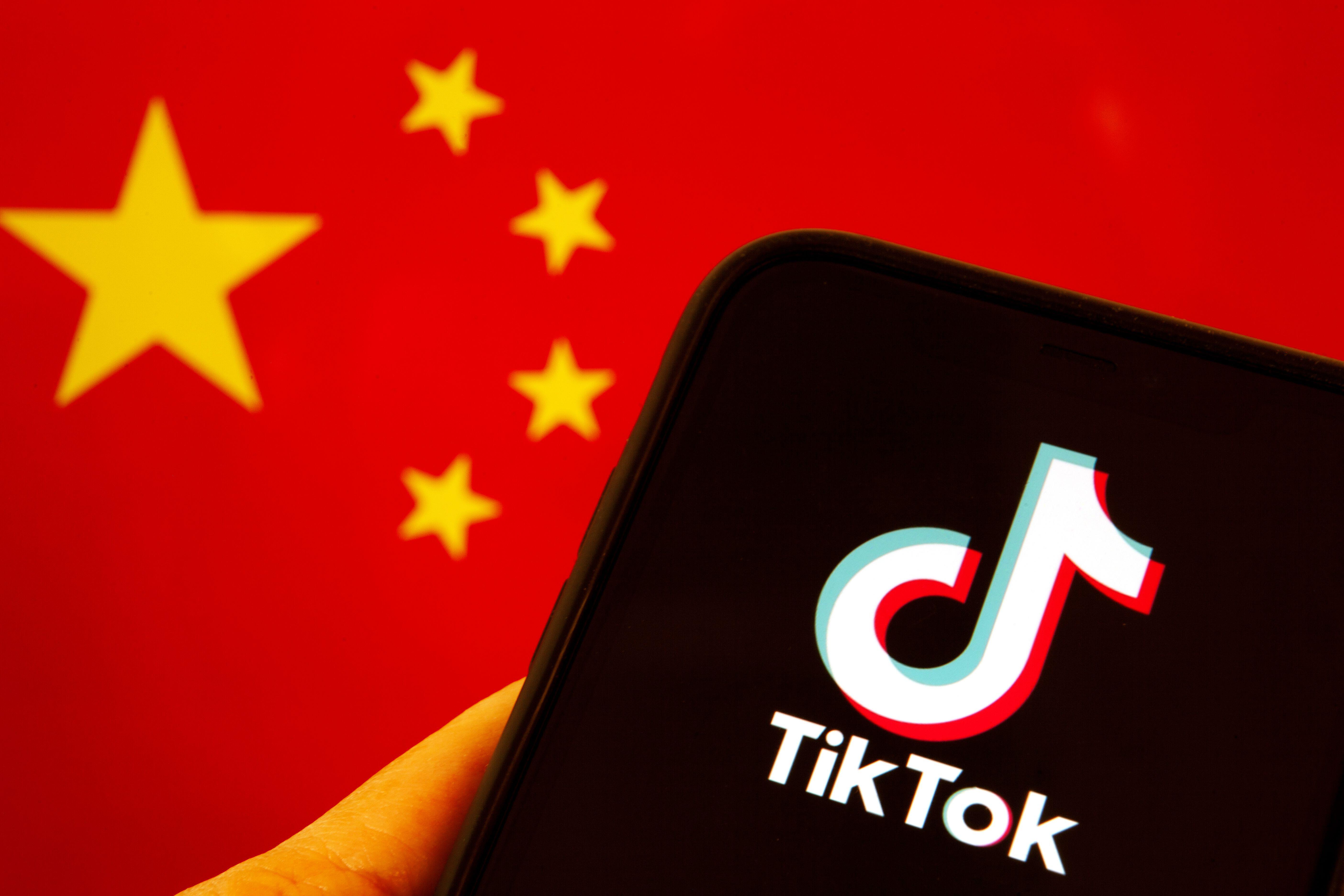 e3786fb1-9222-472c-874e-807b3e27b8ca A mobile phone showing the TikTok logo in front of a China flag