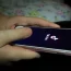 A young girl uses the TikTok app on a smartphone
