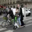 Tourists ride a scooter in Paris, Friday, march 31, 2023