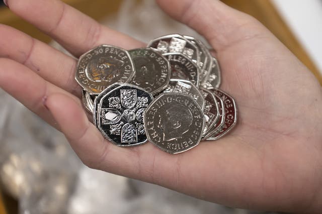 2-70152928 50p coins featuring the portrait of King Charles III at the Aldwych branch which is close to Clarence House, London, and is the residence of the King