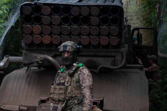 204af7b3c7a04c72ae24f17b7e521f81 A Ukrainian soldier stands next to an MSLR BM-21 'Grad' at the front line near Bakhmut in the Donetsk region, Ukraine