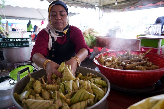 204fba825c904b4cad0068be22dd3256 A Malaysian Muslim vendor cooks ketupat - rice cakes wrapped in woven palm leaf pouches - ahead of Eid celebrations in Kuala Lumpur