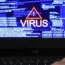 A laptop screen showing a computer virus warning