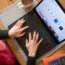 A woman using a laptop on a dining room table