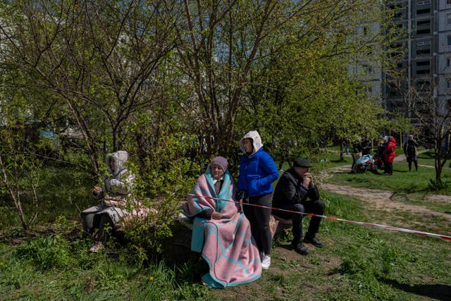 28be26af61024d2db0f6f82685d0f7f4 Residents sit outside a residential building hit during a Russian attack in Uman