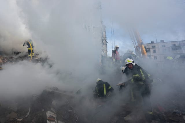 461f59570346488887c42db603677ffd Firefighters work to extinguish a fire after a Russian attack at a residential building in Uman