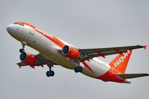 EasyJet cuts losses and insists Britons will not ditch holidays amid cost crisis