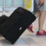 An airline passenger with a suitcase