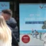 People walk past a Tui shop window