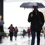Commuters with umbrellas on a rainy morning