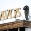 A police officer stands on the roof of a hotel and monitors the area with a binocular in Davos, Switzerland