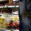 A person holding a shopping basket in a supermarket