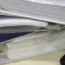 Folders full of paper beside a laptop keyboard