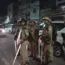 Policemen stand guard in the area where Atiq Ahmad and his brother Ashraf were shot in, Prayagraj, India