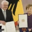 German President Frank-Walter Steinmeier, left, presents the Grand Cross of the Order of Merit of the Federal Republic of Germany in a special design to former chancellor Angela Merkel during a recept