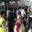 People walk to a bus at Soekarno-Hatta airport in Indonesia after being evacuated from Sudan