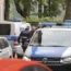 Two judiciary vans, each carrying defendants, drive in a courtyard before the start of the trial against members of the United Patriots group at the Higher Regional Court in Koblenz, Germany