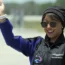 Saudi Arabian astronaut Rayyanah Barnawi waves to family and friends as she arrives at the Kennedy Space Centre in Cape Canaveral, Florida