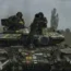 Ukrainian soldiers on a tank heading towards their positions near Bakhmut