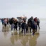 Channel migrants are pictured being taken onto shore by Border Force officials in May this year