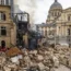 Firefighters work at the site of the explosion in Paris