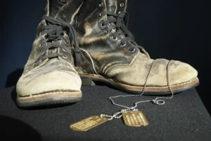 Alan Alda selling boots and dog tags from M*A*S*H