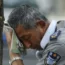 A security guard wipes away sweat on a hot day in Beijing