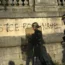 Police patrol past graffiti reading 'Justice for Nahel' as youths gather on Concorde Square during a protest in Paris