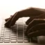 Someone typing on a laptop