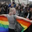 A gay rights activist stands with a rainbow flag during a protest in St Petersburg, Russia