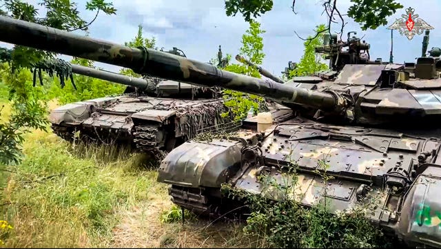 Tanks belonging to Russia’s Wagner military contractor are parked ahead of their handover to the Russian military at an undisclosed location