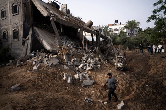 617177c5f1514fbdac7b804ad87ea2b8 Palestinians inspect the rubble of a house after it was struck by an Israeli air strike in Deir al-Balah, central Gaza Strip
