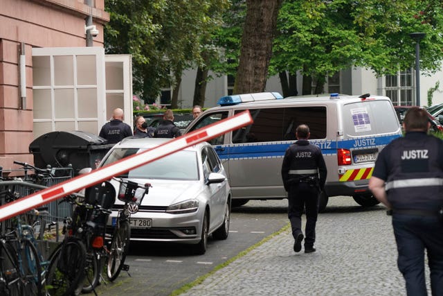 6c64e1212efa4e24b01385eb0003eeb8 Judiciary vans, each carrying defendants, drive in a courtyard before the start of the trial against members of the United Patriots group at the Higher Regional Court in Koblenz, Germany