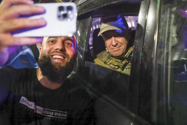 7eec145a68f64fa2bc993ef7f16feb01 Yevgeny Prigozhin, the owner of the Wagner Group military company, right, sits inside a military vehicle posing for a selfie with a local civilian on a street in Rostov-on-Don, Russia, on Saturday