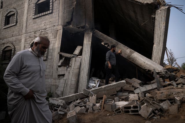 92254712517443f6b54f2e42c89e25f5 Palestinians inspect the rubble of a house after it was struck by an Israeli air strike in Deir al-Balah, central Gaza Strip