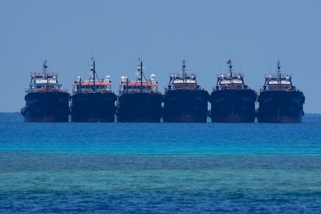 9dd79c2cb7884cbfb2bb16dc9c5579bf Some of the many suspected Chinese militia ships lay side by side at the Philippine-claimed reef called Whitsun